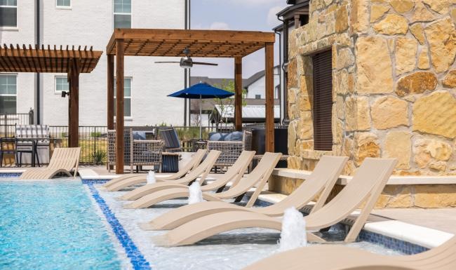 Resort-style swimming pool with lounge seating