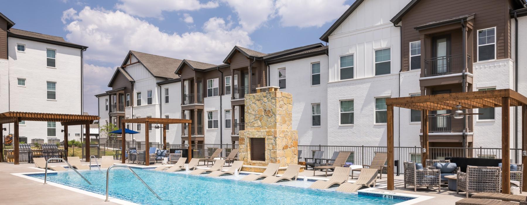 Resort-style swimming pool with lounge seating